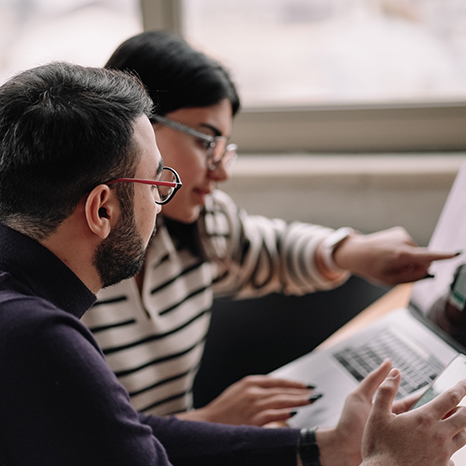 Two people looking at a computer
